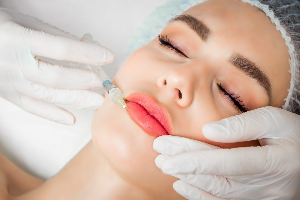 Practitioner examining a patient’s lips