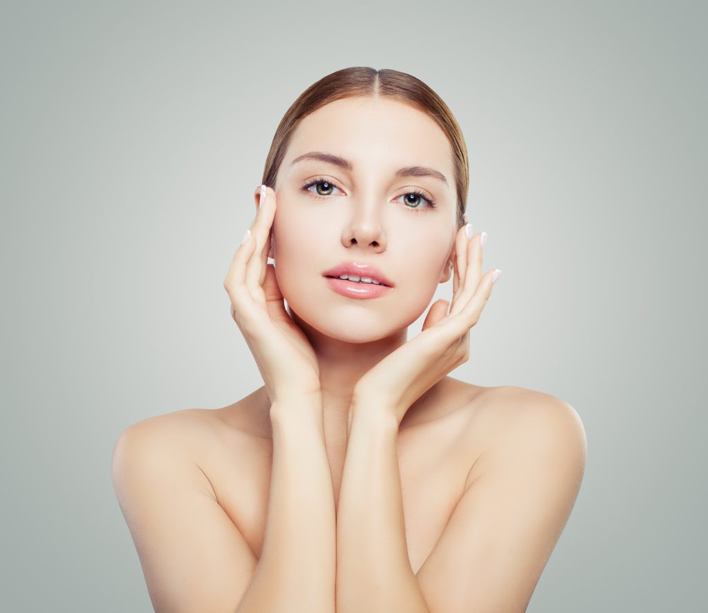 Woman with smooth, healthy-looking skin touching her face