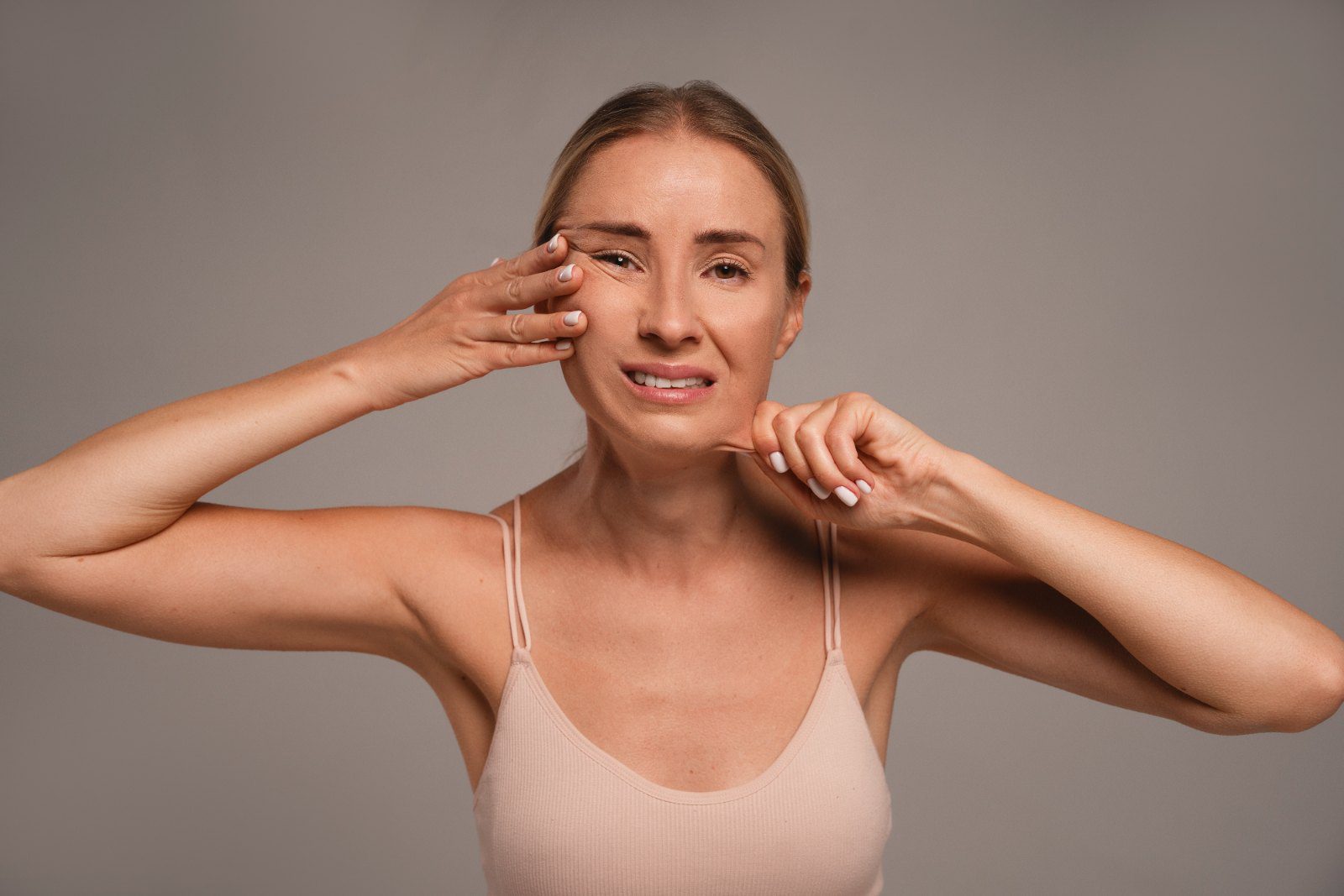 Woman gently lifting the skin on her face with her fingers