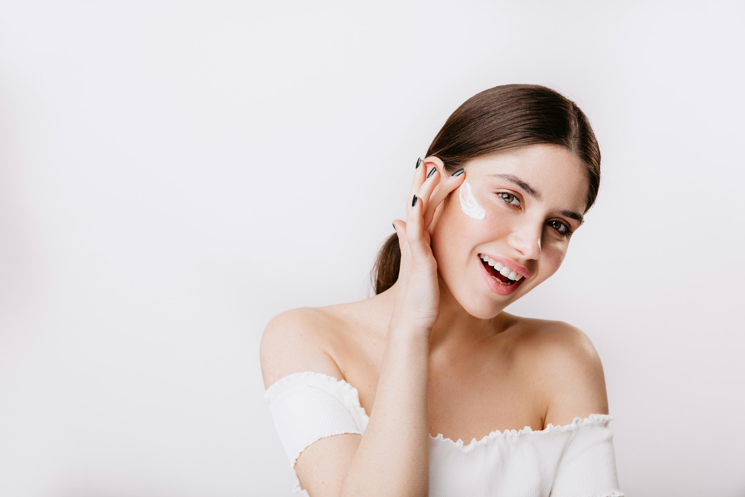 Smiling woman caring for her skin